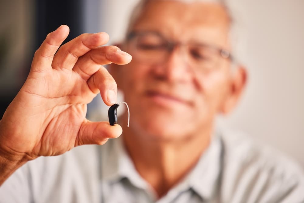 man holding hearing aid